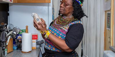 Older woman in kitchen looking at ingredients