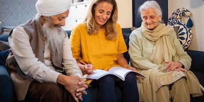 Three older people on a sofa