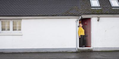 Older woman in house doorway