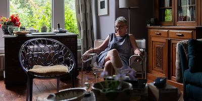 Older woman sat at home