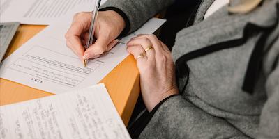 Person-writing-on-paper