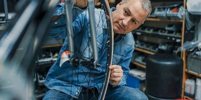 Older-man-working-with-a-bike