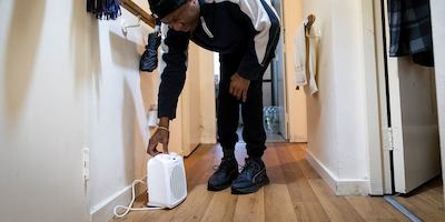 Older-man-adjusting-dehumidifier