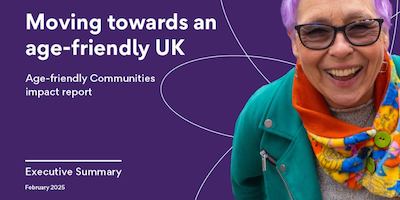 Older woman with purple hair smiling into the camera