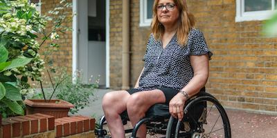 Older woman in a wheelchair looking at the camera