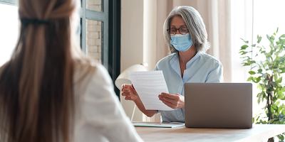 Older-woman-in-a-mask-at-a-job-interview