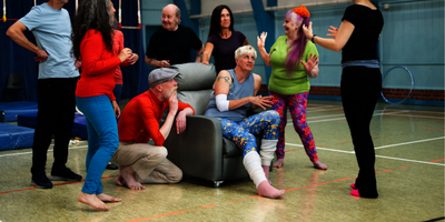 A group of people chat inside a circus