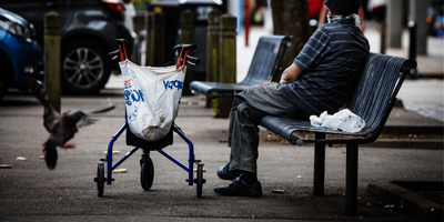 An older man sitting on a bench
