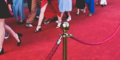 A photo of people walking down a red carpet