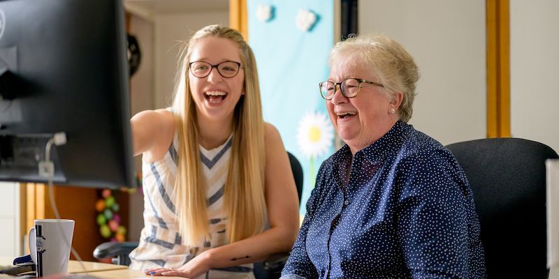 Two people talking in an office setting