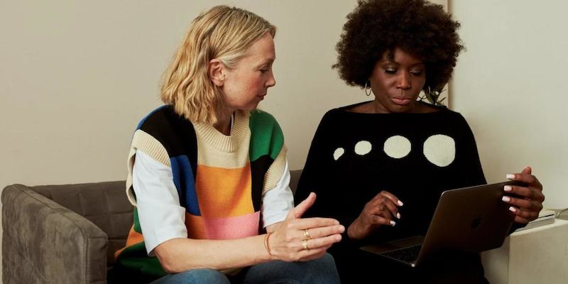 two people sitting and talking