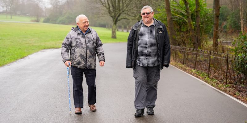 Two men walking in a park