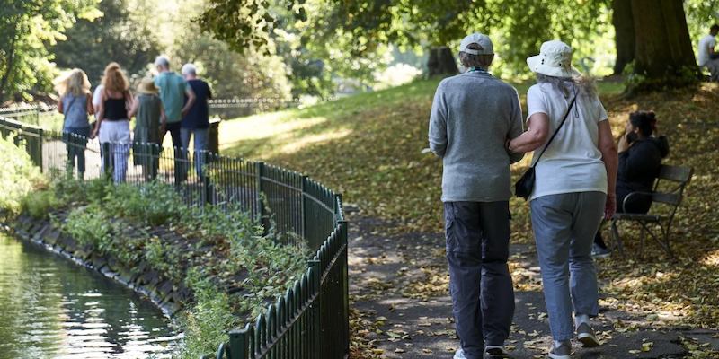group of older people walking in a park