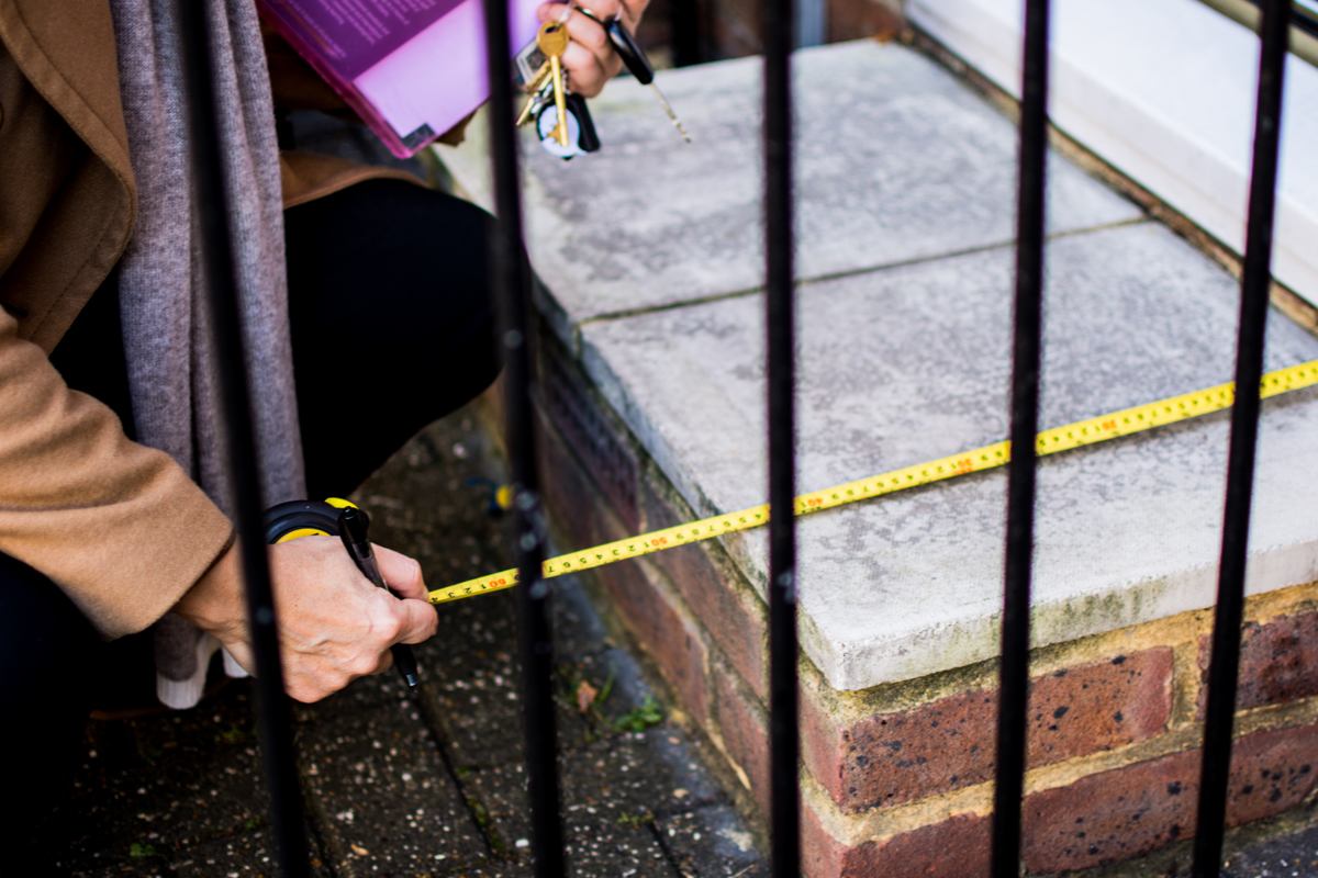 Occupational therapist measuring step at front door