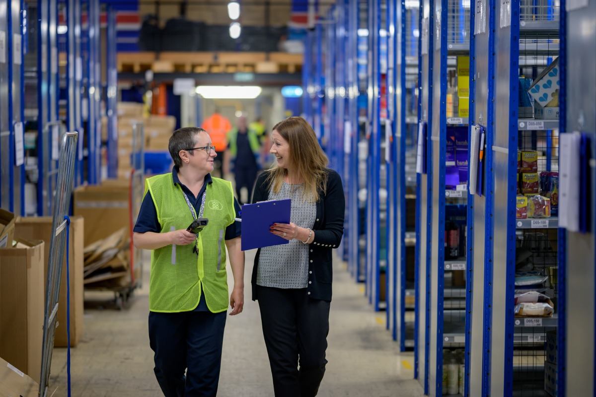 two women working together in a warehouse