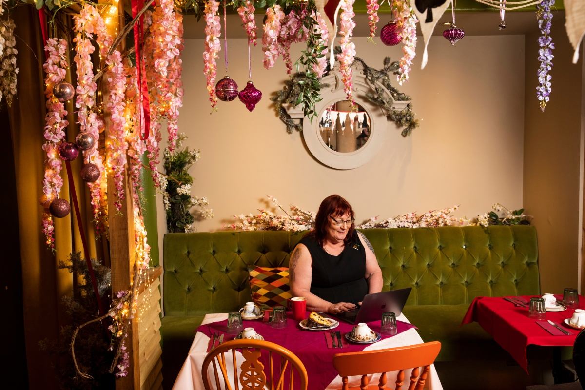 Rachel, on her laptop in a cafe 