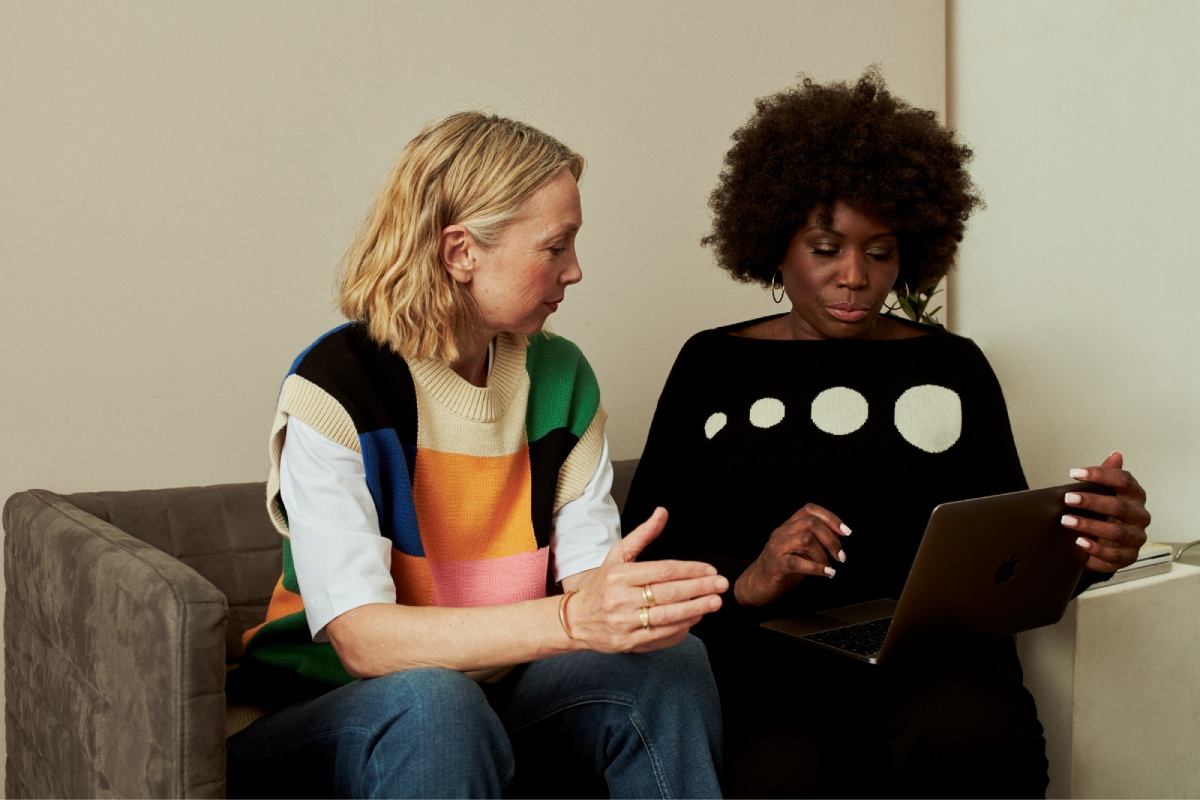 Two older woman working on a laptop