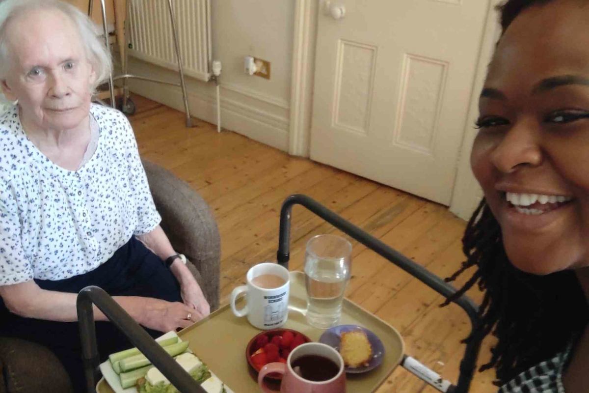 2 women smiling with tea