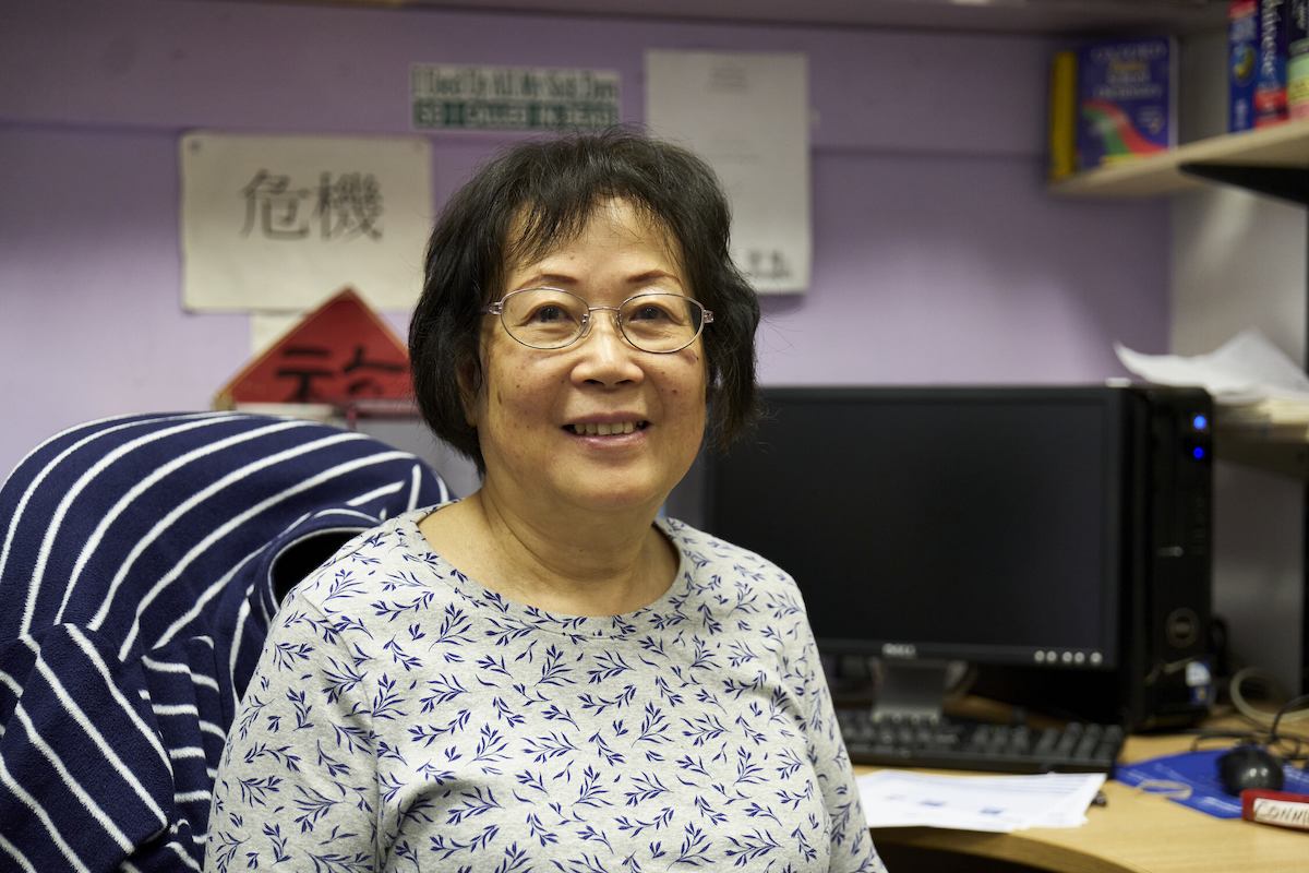 Person sitting at a desk looking at the camera