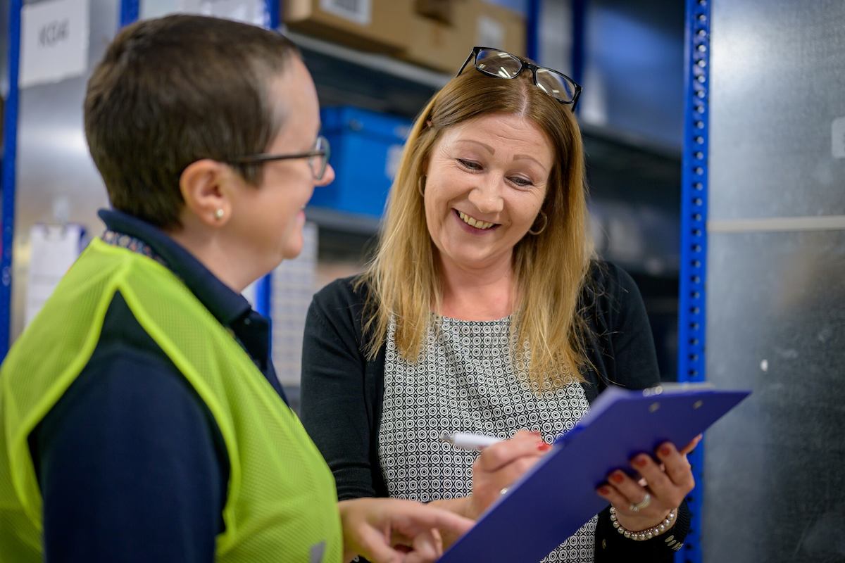 Two people talking in an industrial setting