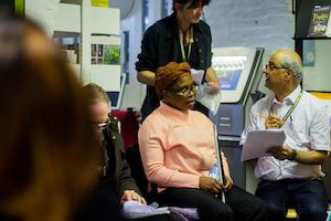 Visually impaired lady and a volunteer working through a quiz