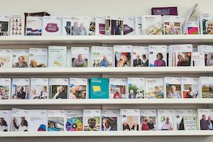 Racks along wall with publications.