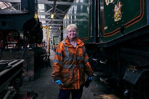 Older woman standing by railway