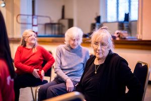 Valerie an older woman sitting on a chair