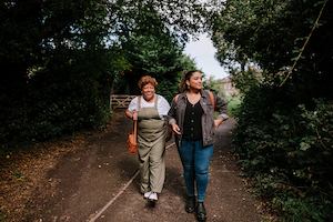 Older and younger people walking together