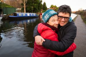 Jo and Liz hugging each other by a canal
