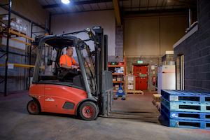 Image of a man moving pallets in a factory