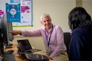 Two older women working from a desk