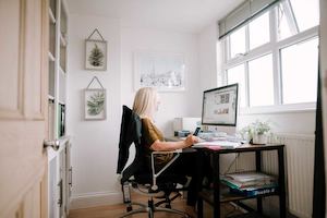 Blonde woman working at computer