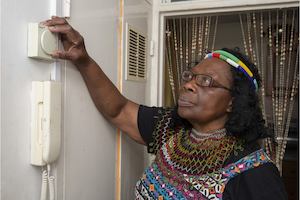 Older woman checking thermostat
