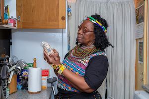 Older woman in kitchen looking at ingredients