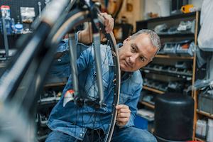 Older-man-working-with-a-bike