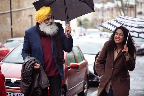 Older sikh man walking with younger woman