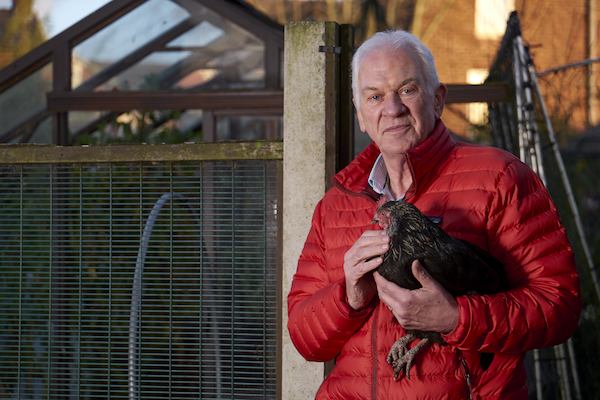 Man holding a chicken