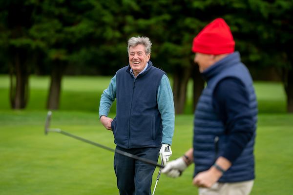 Two men playing golf