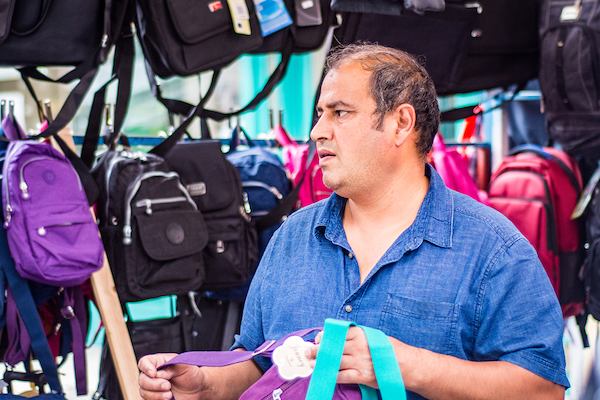 older worker selling bags