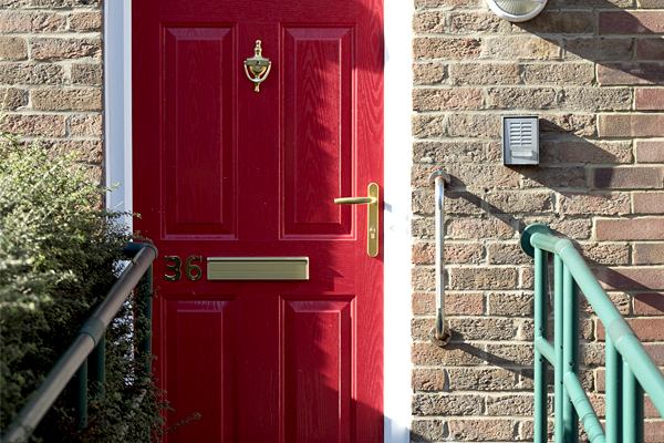 Red front door with grab rails