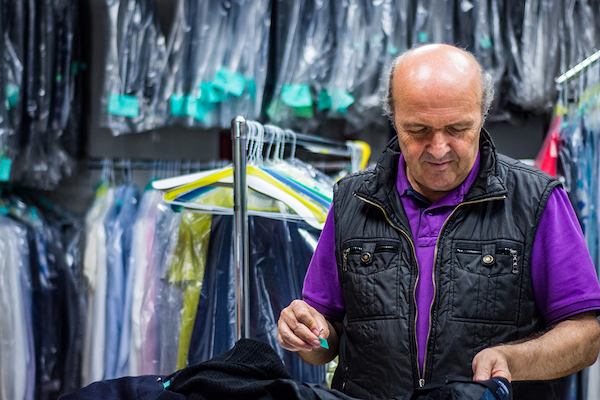 Older worker in dry cleaners