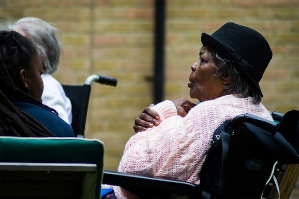 Older black woman sitting in wheelchair