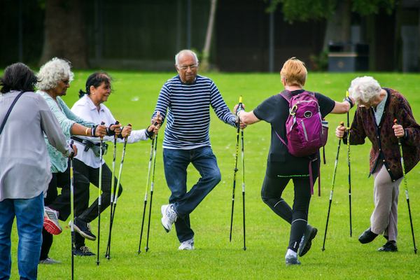 Group of people 'Nordic' walking in the park