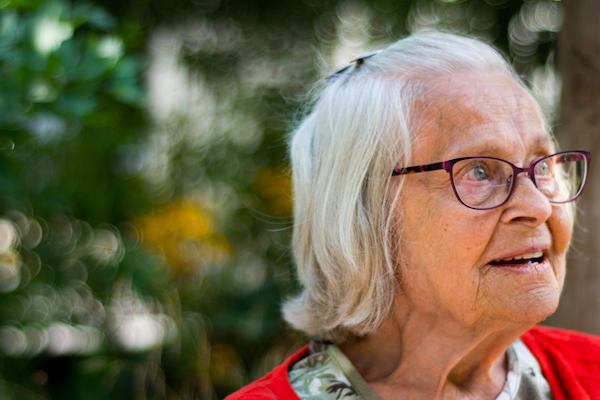 Older woman sitting on a park bench