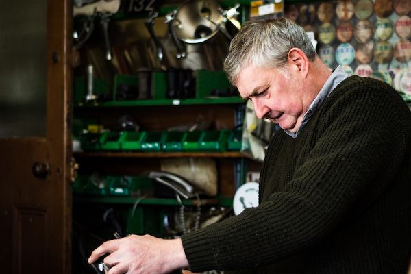 Older worker in a bike shop