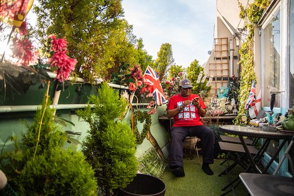 Older man in garden using mobile phone