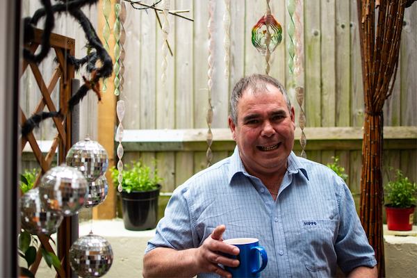 Man in a garden holding a mug of tea