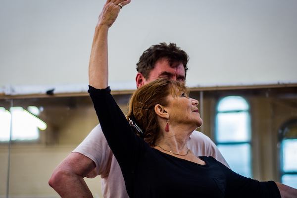 Older woman doing ballet with instructor.