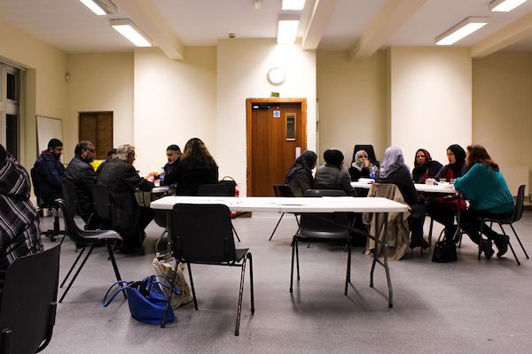 People seated at tables at job centre.